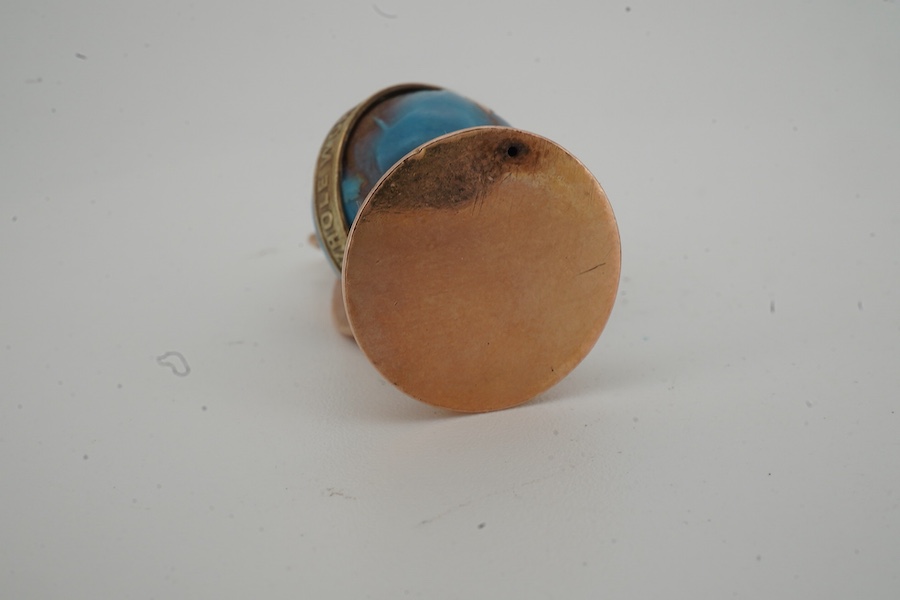A yellow metal and enamel globe charm, reading 'The whole world turns round the love', height 3.2cm; and a gold and amber pendant, length 4.5cm, Russian assay marks for 14ct gold
